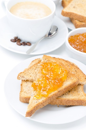 toast with orange jam and cup of cappuccino for breakfast closeupの写真素材