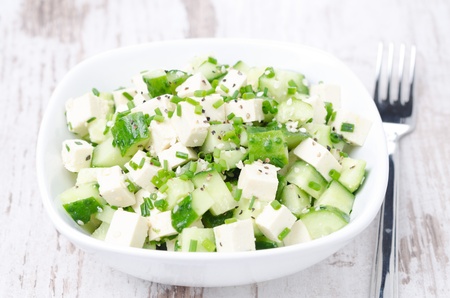 salad with cucumber, tofu, green onions and sesame seeds in a bowlの写真素材