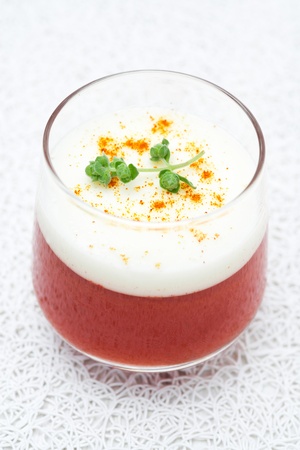 bilayer tomato panna cotta with smoked pepper and yogurt in a glass, top view, verticalの写真素材