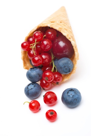Assorted fresh seasonal berries in a waffle cone isolated on white backgroundの写真素材