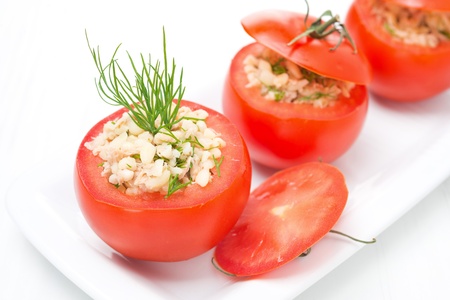 Fresh tomatoes stuffed with tuna salad and bulgur on the white plate, close-upの写真素材