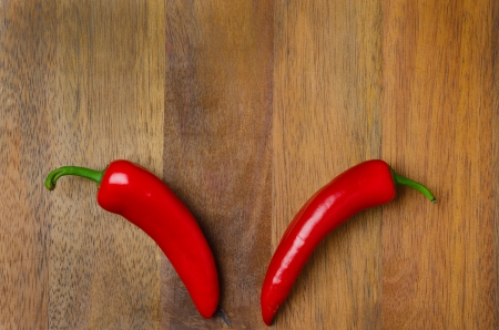 red hot chili peppers on a wooden background, horizontal, top viewの写真素材