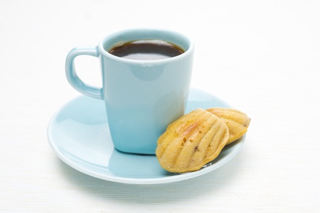 cup of coffee and madeleines cookies on a white background, horizontalの写真素材