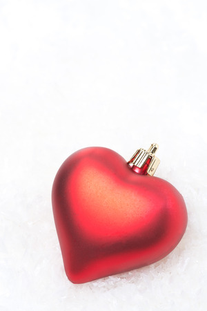 Christmas decorations in the form of hearts in the snow, isolated on whiteの写真素材