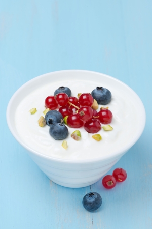 fresh sweet yogurt with berries and pistachios, top viewの写真素材