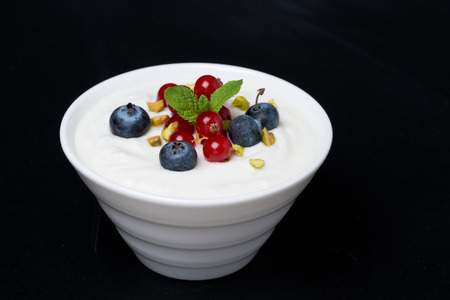 natural yogurt with fresh berries on a black の写真素材