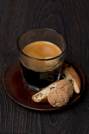 glass of espresso, biscotti and almond cookies, selective focus, verticalの写真素材