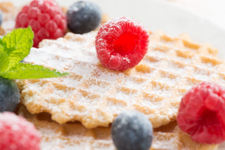 sweet Belgian waffles with fresh berries, selective focus, close-up