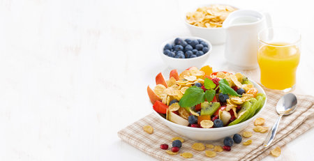 breakfast with fruit and berry salad, juice and cereal, horizontal