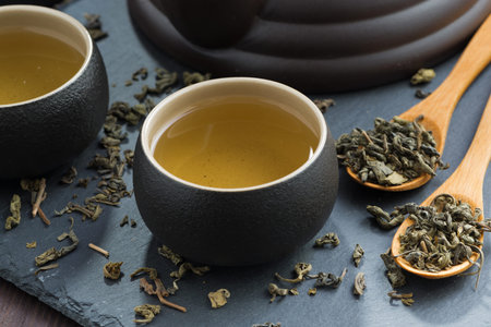 pialas with green tea on a dark background, close-up, horizontal