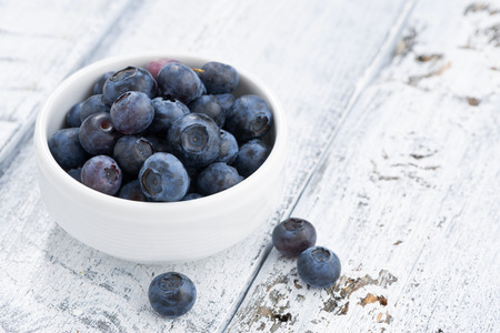 bowl of fresh blueberries on white wooden background, closeupの写真素材