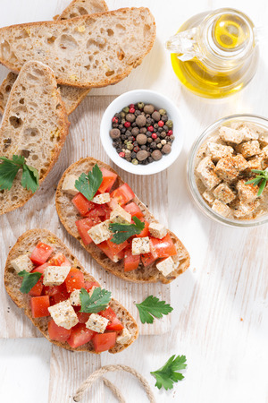 ciabatta with tomatoes and marinated feta, top view verticalの写真素材