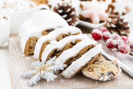 Christmas Stollen on a wooden board and cookies, closeup, horizontalの写真素材