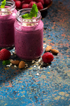 berry smoothie in a bottle on a dark background, vertical, closeupの写真素材