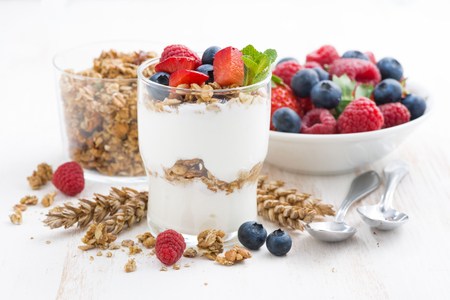 healthy dessert with natural yogurt, muesli and berries on a white background, closeup, horizontalの写真素材