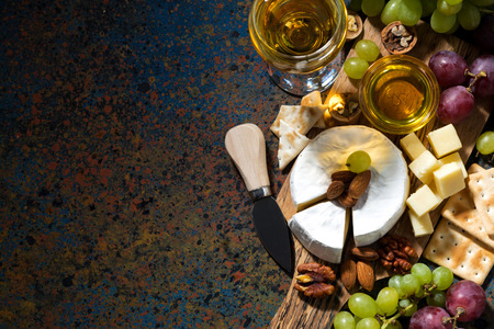 snacks, wine and camembert and dark background, top view, horizontalの写真素材