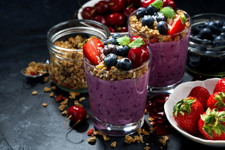 healthy blueberry with granola and berries on a dark background, closeupの写真素材