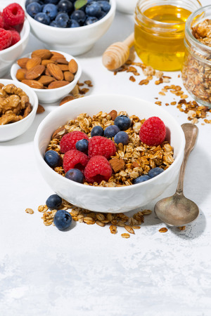 cottage cheese with granola and fresh berries for breakfast, vertical closeupの写真素材