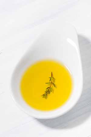 olive oil with thyme in a bowl, top viewの写真素材