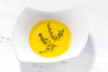 olive oil with thyme in a bowl, top viewの写真素材