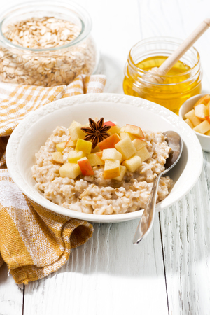 plate of oatmeal with apples and spices, vertical, closeupの写真素材