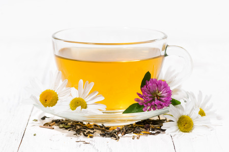fragrant herbal tea in a cup on white wooden background, closeup horizontalの写真素材