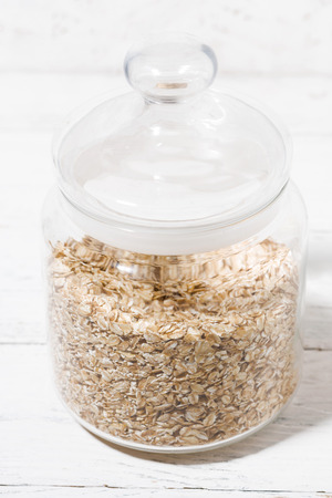 glass jar with oat flakes, verticalの写真素材