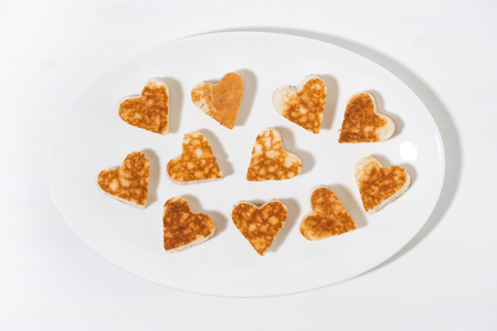 plate of pancakes in the shape of heart, top viewの写真素材