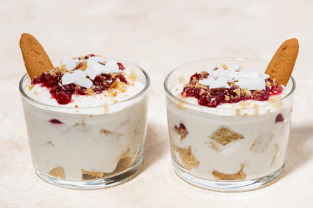 delicious dessert in a glass with cookies, cream and jam, closeupの写真素材