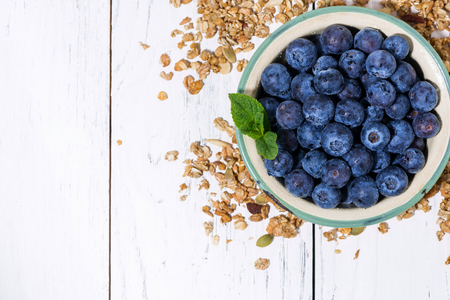 Fresh juicy blueberries and homemade granola, top view horizontalの写真素材