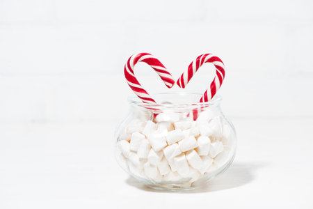 sugar candy in the shape of a heart in a jar of marshmallows, horizontalの写真素材
