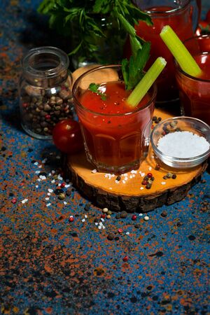 Fresh healthy tomato juice with salt and celery, top view verticalの写真素材