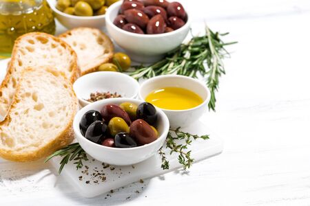 fresh organic olives, spices and bread on white table, closeupの写真素材