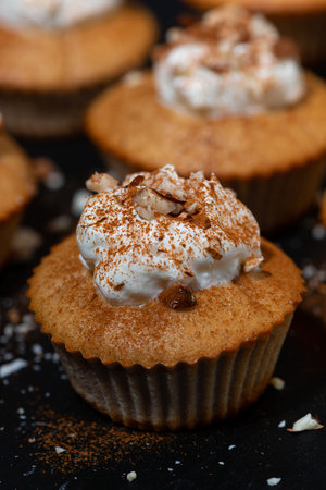 portioned mini cakes with whipped cream, vertical closeup