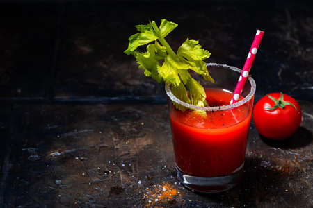 glass of alcoholic cocktail bloody mary on dark background, top view horizontalの写真素材