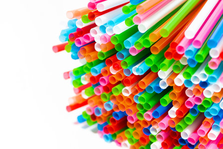 colored plastic tubes for cocktails on white background, closeup horizontal