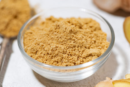 dried ginger in a glass bowl on white background, closeupの写真素材