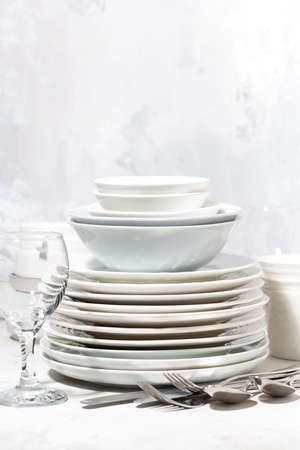 Tableware, cutlery and glasses on a white tableの写真素材