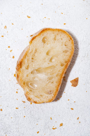 slice of baguette on a white background, top view vertical