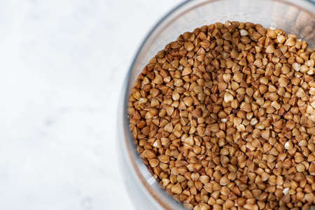 buckwheat groats in a glass jar on white background, top view horizontalの写真素材