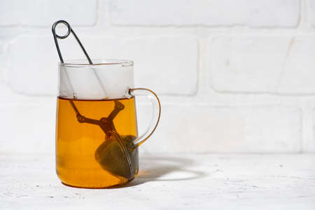 glass cup with brewing black tea, horizontalの写真素材