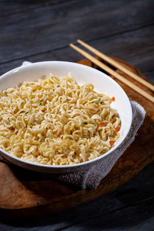 plate of fresh hot noodles on dark background, top viewの写真素材