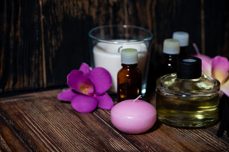 attributes of spa treatments - candles, aroma diffuser and aroma oils on wooden background, horizontalの写真素材