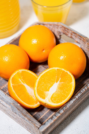 fresh oranges on a wooden tray, top viewの写真素材