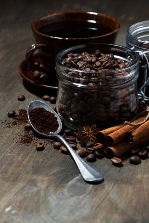 roasted coffee beans and spices on wooden background, vertical closeupの写真素材