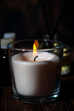 burning aroma candle on a dark background, verticalの写真素材