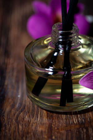 aroma diffuser and rattan sticks on dark wooden background, spa attributes, vertical closeupの写真素材