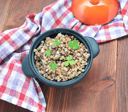 Buckwheat groats in a wooden brown tableの写真素材