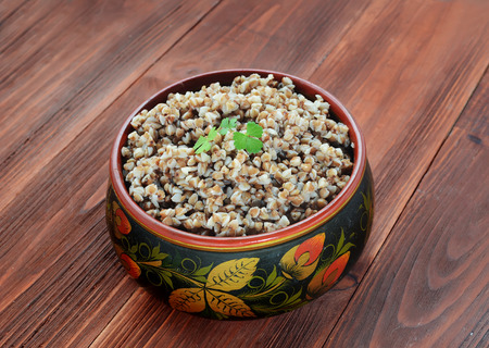 Buckwheat groats in a wooden painted bowlの写真素材