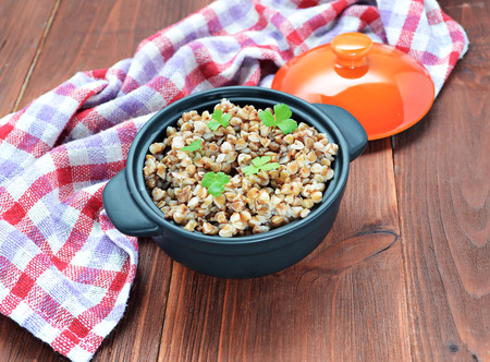 Buckwheat groats in a wooden brown tableの写真素材